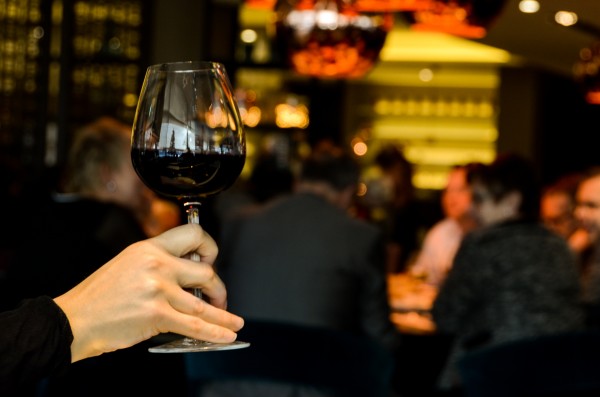 Lady holding glass of red wine