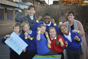 Jefferies' Director Nina Ramsden with primary school children after donating reflective safety bands