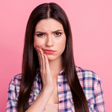 Woman who is in pain because of a tooth injury.