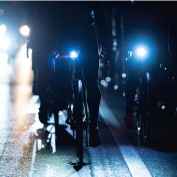cyclists on their bike in the dark